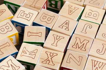 Alphabet blocks ABC on wooden table.