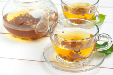 teapot and cups of tea on a white wooden background