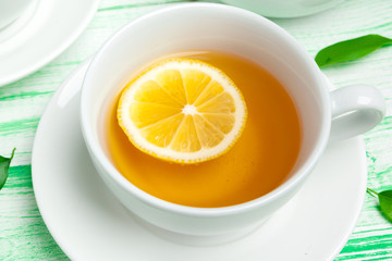 Black tea on green wooden background