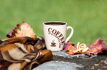 Cup with coffee in the autumn park