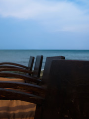 Brown wood chair Put together on the beach On the sea and sky background
