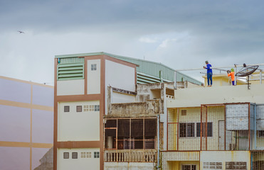 Worker welding the steel part for roof  before it is going to rain.