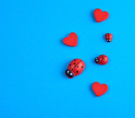 wooden decor red heart and ladybug on a blue background