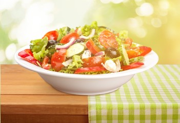 Close-up photo of fresh salad with vegetables in white plate