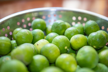 Focus and Blur on Green lemon lime or Thailand lemons on metal basket. Abstract of sweet, sour flavor and Thirsty.