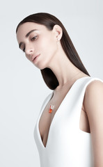 Fototapeta premium Young woman with stylish necklace looking away