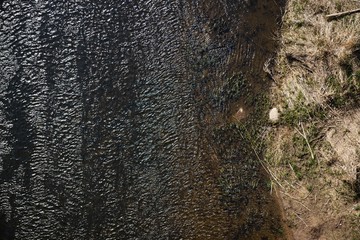 Aerial top view, countryside spring panorama of small quiet river on sunny day
