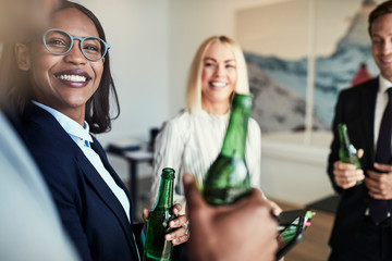 Smiling African American businesswoman talking with colleagues o