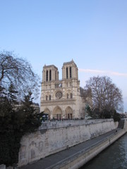 View of the Notre Dame cathedral at sunset with many tourists