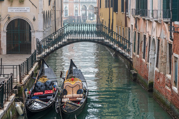 Fototapeta na wymiar Two gondolas and bridge above canal in Venice, Italy