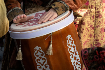 Street musician plays the traditional Asian drum. Close-up