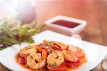 Delicious cooked shrimps with tomatoes on white plate
