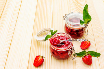 Strawberry jam in a glass jar.