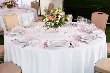 Serving a round table in the restaurant for several people. Selective focus.