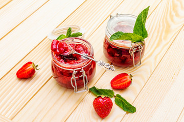 Strawberry jam in a glass jar.