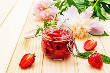 Strawberry jam in a glass jar.