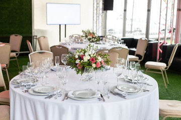 Serving a round table in the restaurant for several people. Selective focus.