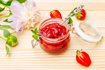Strawberry jam in a glass jar.