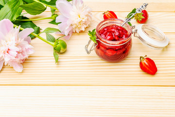Strawberry jam in a glass jar.