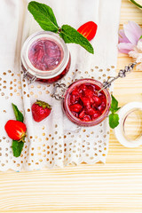 Strawberry jam in a glass jar.