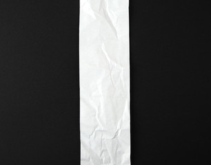  blank strip of paper on a black background