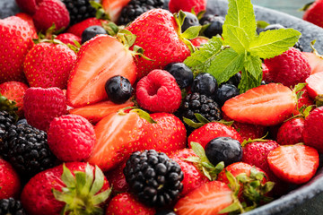close-up view of fresh strawberries, blackberries and blueberries