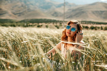 portrait of a young girl in a white translucent dress in boho or hippie style © AJ_stock_photos