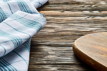 Fototapeta na wymiar Old dark wooden background. Wooden table with green tea towel