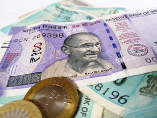 Indian currency two thousand one hundred rupee note and coins