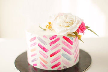 Cake with pink stripes and floral decorations