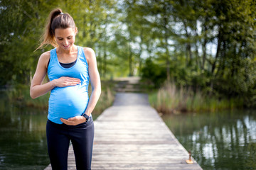 Pregnant woman walking in the park, sport during pregnancy