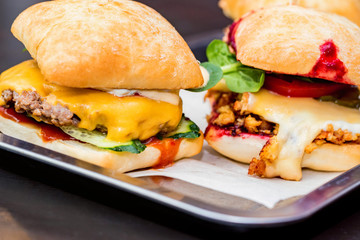Close up three tasty burgers with different filling served on tray