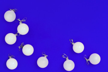 New Year white holiday balls. Christmas decor for postcard or invitation. Creative minimal celebration concept for xmas. Flat lay. Top View.