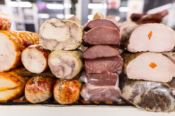 Variety of smoked and fried meat products. Traditional marketplace.