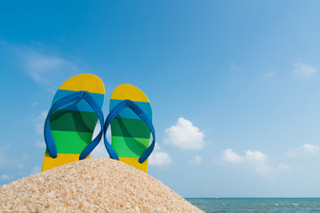 Beach sandals on the sandy coast. Summer concept