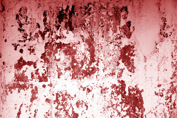 Сraked weathered cement wall texture in red tone.