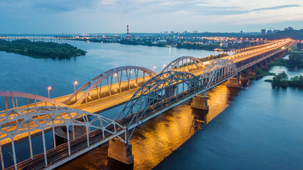 aerial night city view, luminous buildings and bridge. Drone shot.