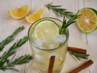 Glass of tasty cold lemonade on wooden background