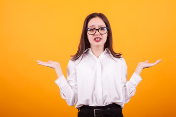 Young teenager girl with her hands up in the air