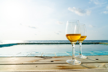 whiskey glass with swimming pool and sea background