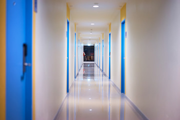 Corridor hallway of hotel with blue doors.
