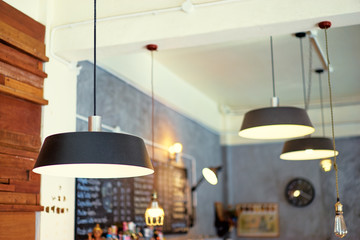 Modern lanterns in cafe interior.