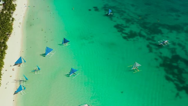 Tropical white sand beach with sailing yachts, hotels near the blue lagoon and corall reef. aerial view, Boracay, Philippines. Seascape with beach on tropical island. Summer and travel vacation