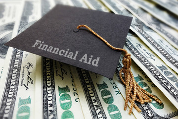 Financial Aid graduation cap on money