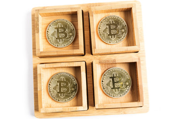 several bitcoin gold coins inside some wooden bowls