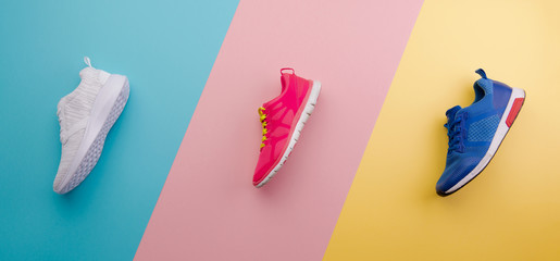 A studio shot of running shoes on bright color background. Flat lay. - obrazy, fototapety, plakaty