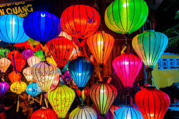 Fototapeta na wymiar Colourful cloth lanterns lamp light shades hanging outside in Hoi An, Vietnam