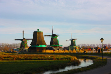 Fototapeta na wymiar the famous Zaanse Scans mills in Zaandam, on the Zaan river. famous holland attraction, windmills.