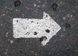 Right pointing arrow on asphalt.