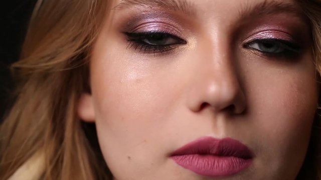 Professional makeup for a young girl on a black background